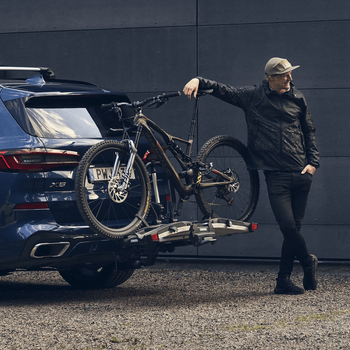 Thule EasyFold XT 2 loaded with a mountain bike behind a car