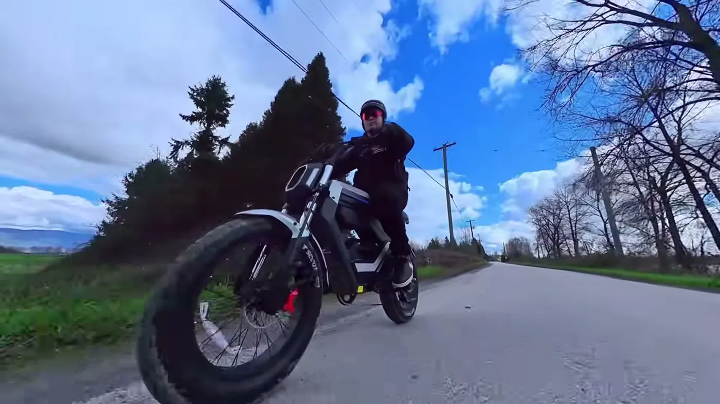 riding toward the camera on a dry road