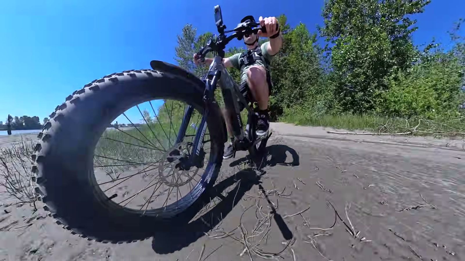 Aventon Aventure M riding through loose sand on the beach in turbo