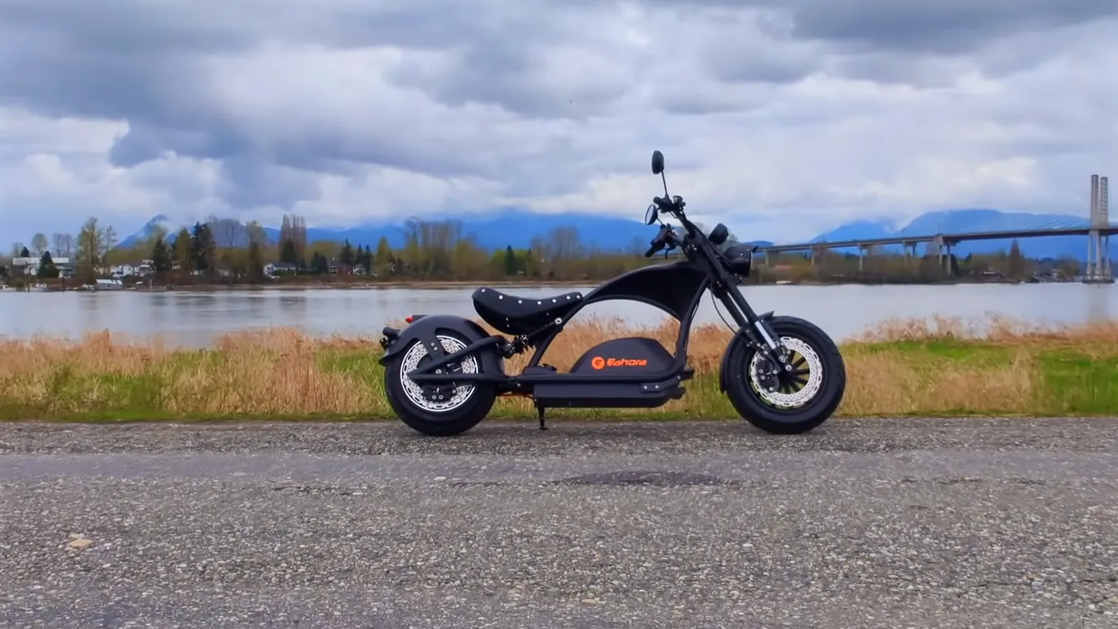 The Eahora Knight M1PS parked on a road beside a river