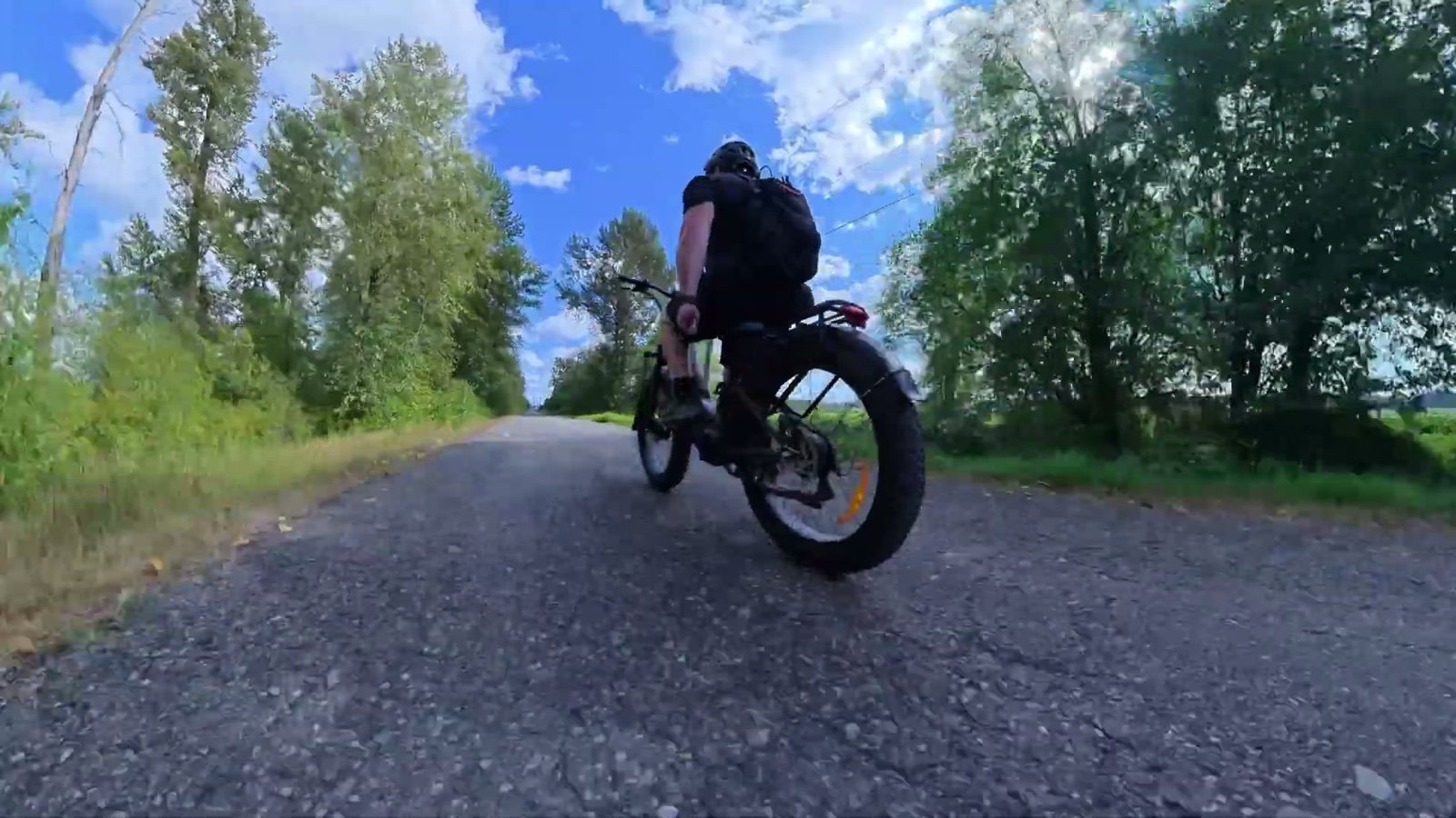 Ben riding the E26 3.0 away down a gravel road
