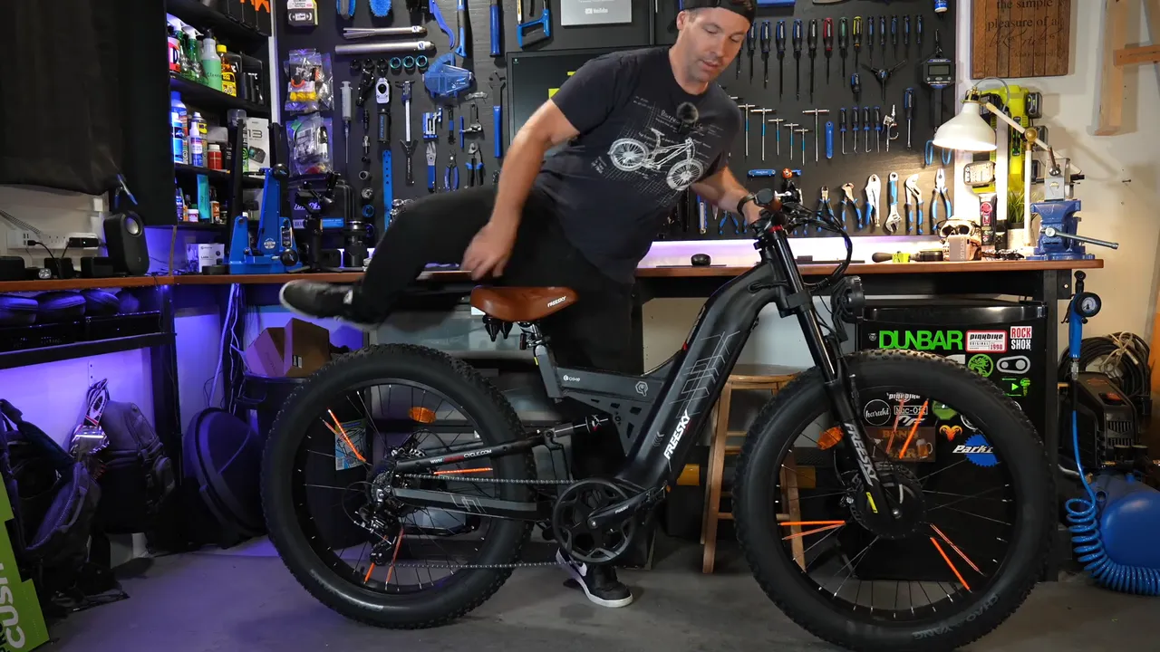 Ben, 5'9", climbing onto the Freesky Warrior Pro in his studio