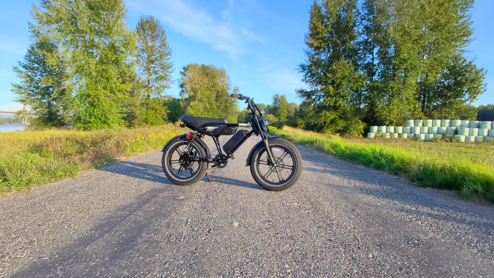 Drone shot of the Heybike Titan parked on a gravel road between trees