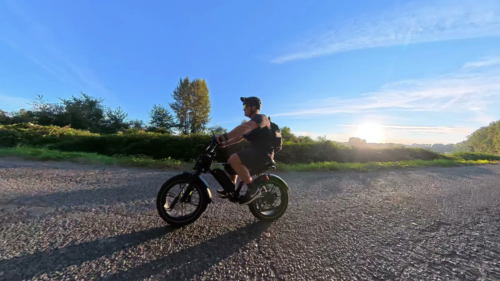 Ben riding the Heybike Titan on gravel at sunset