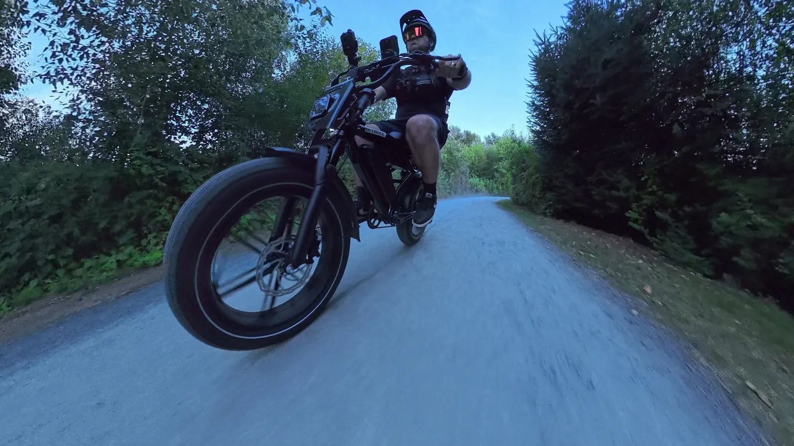 Low front-wheel view of Ben riding the Heybike Titan down a gravel trail