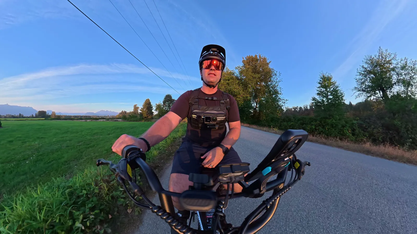 Handlebar camera view of Ben riding the Heybike Titan with mountains behind