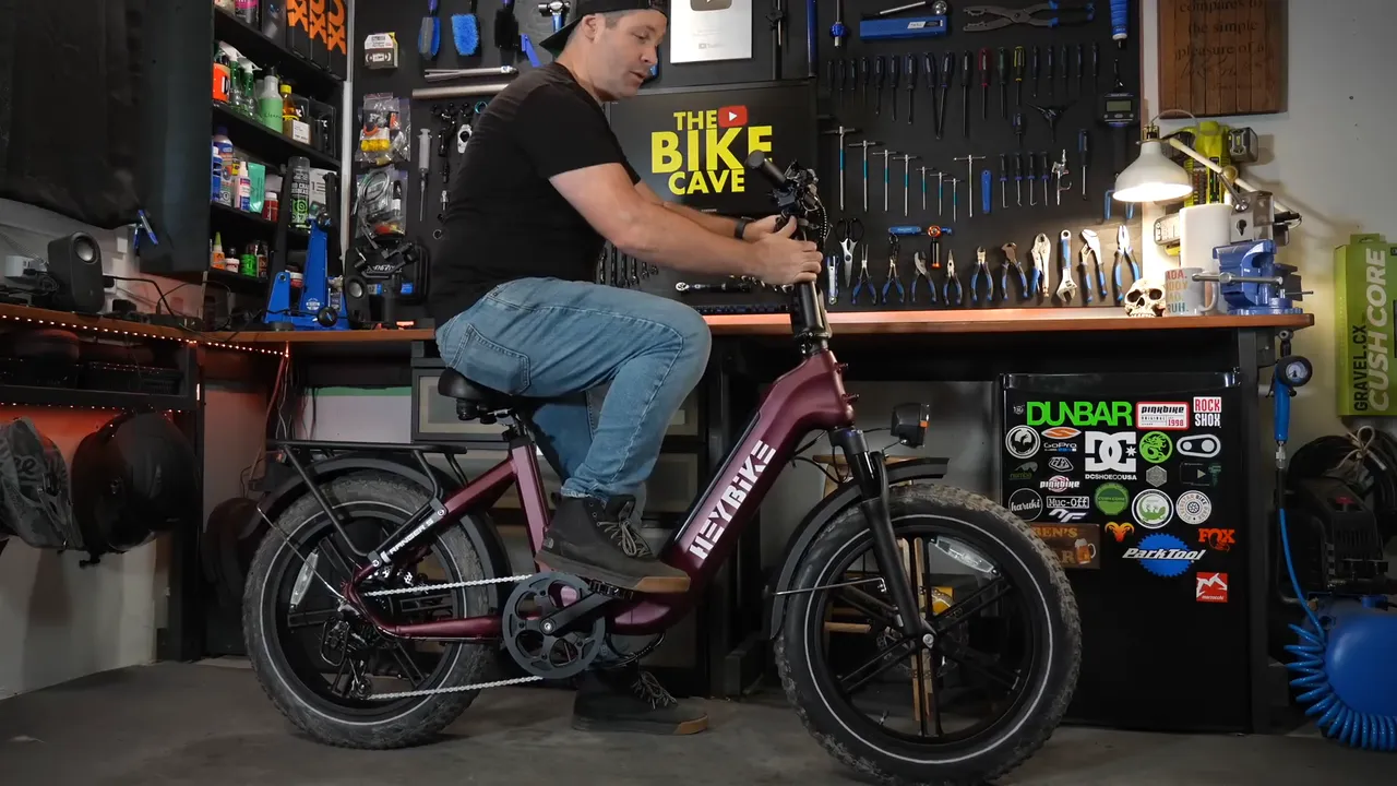 Ben, 5'9", sitting on the Heybike Ranger S in his studio