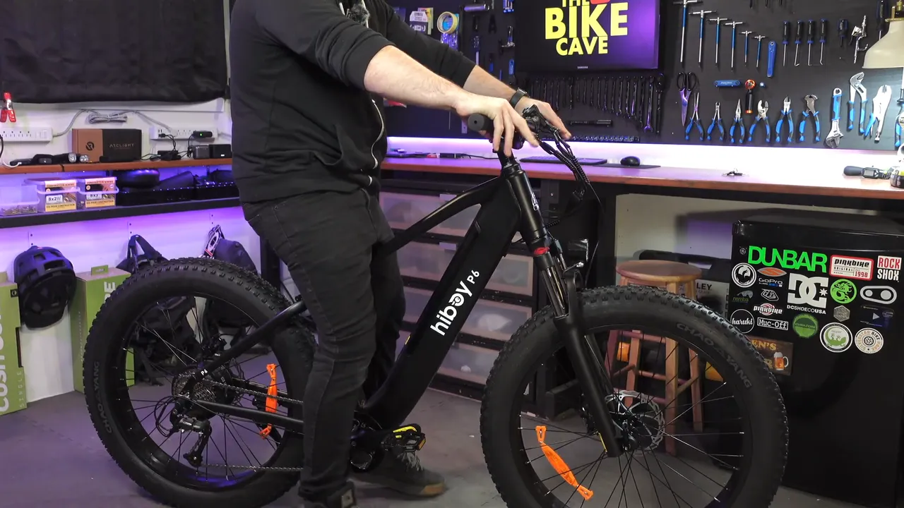 Ben, 5'9", standing over the Hiboy P6 in his studio