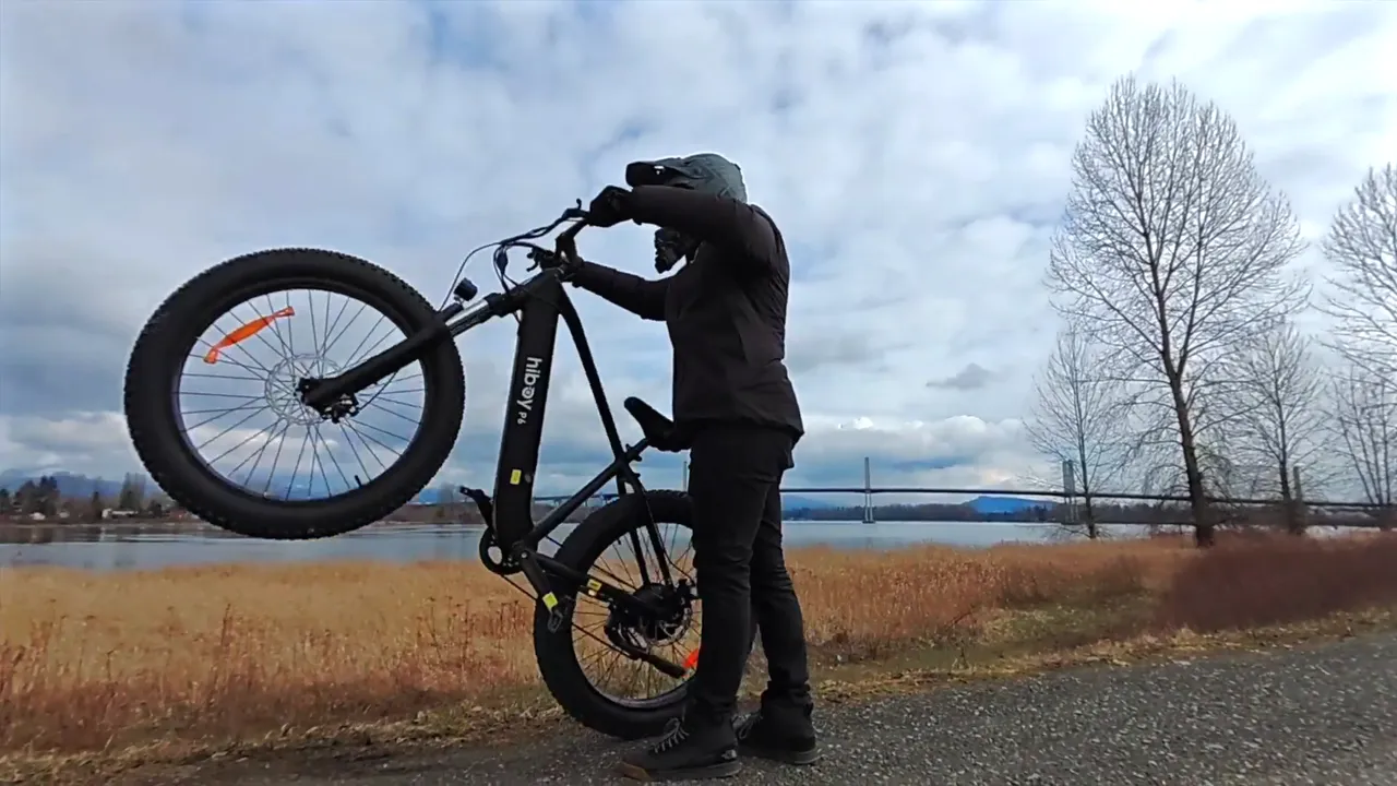 The Hiboy P6 on its rear wheel by a river