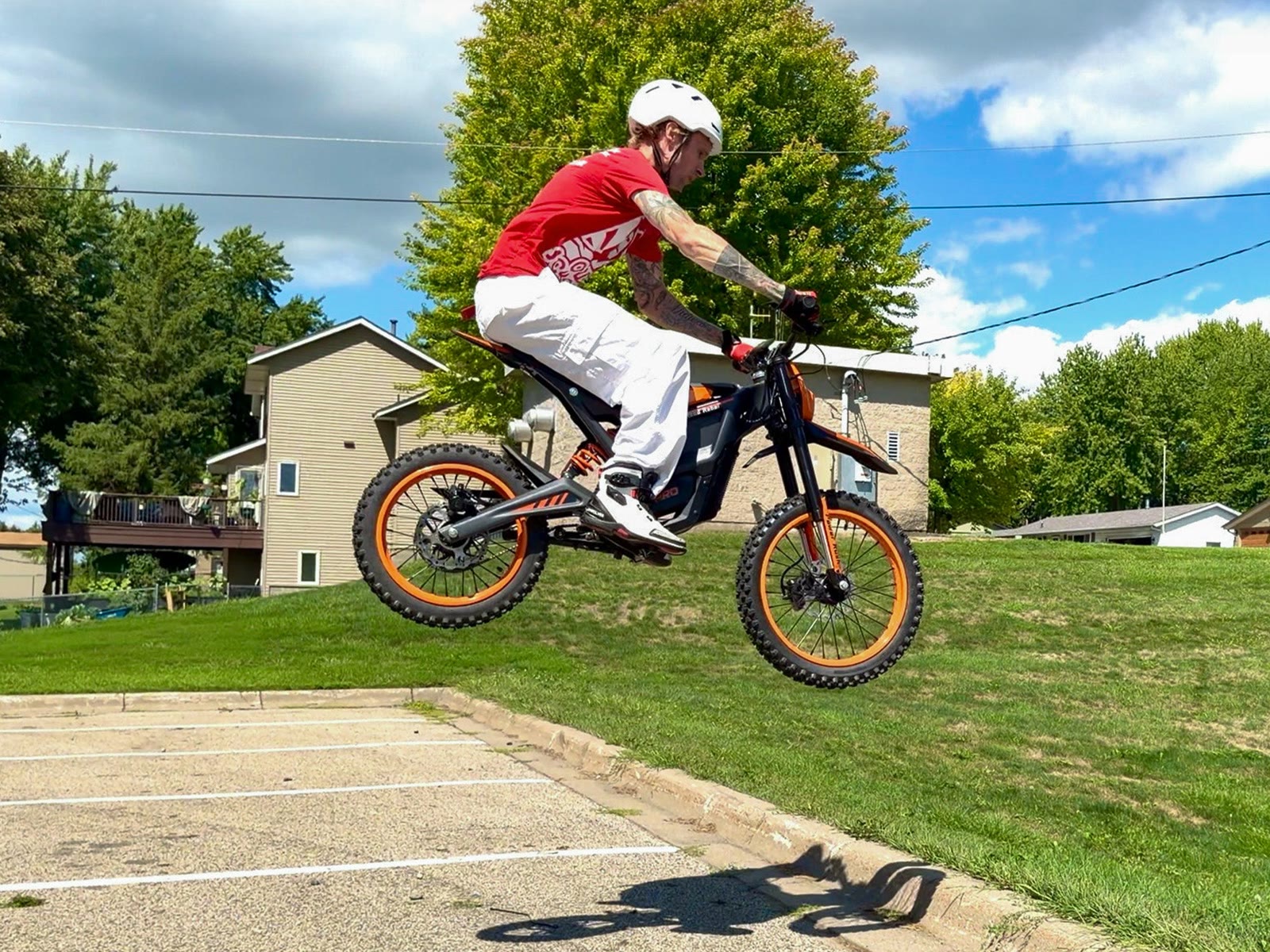 Monster Pro in the air over a grass bank