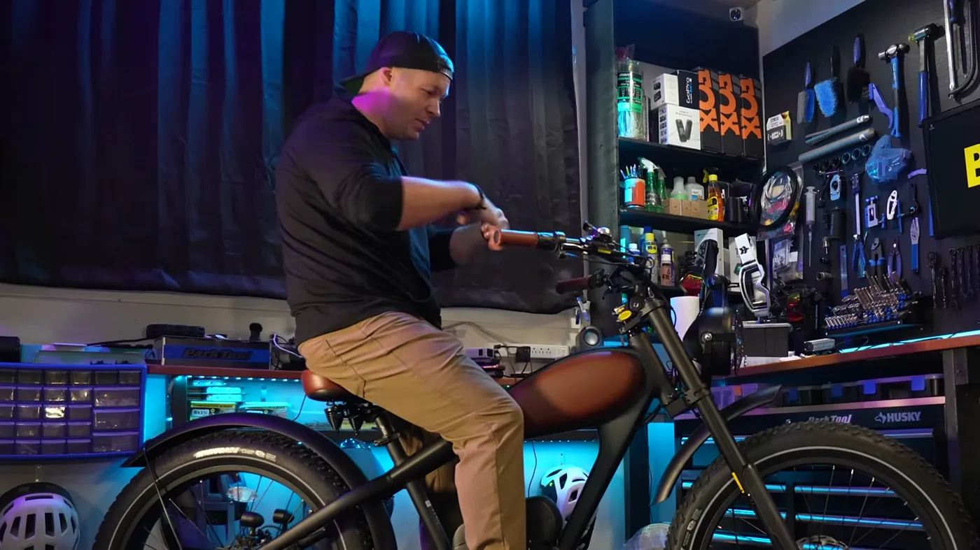 Ben, 5'9", sitting on the Revibikes Cheetah Pro in his studio