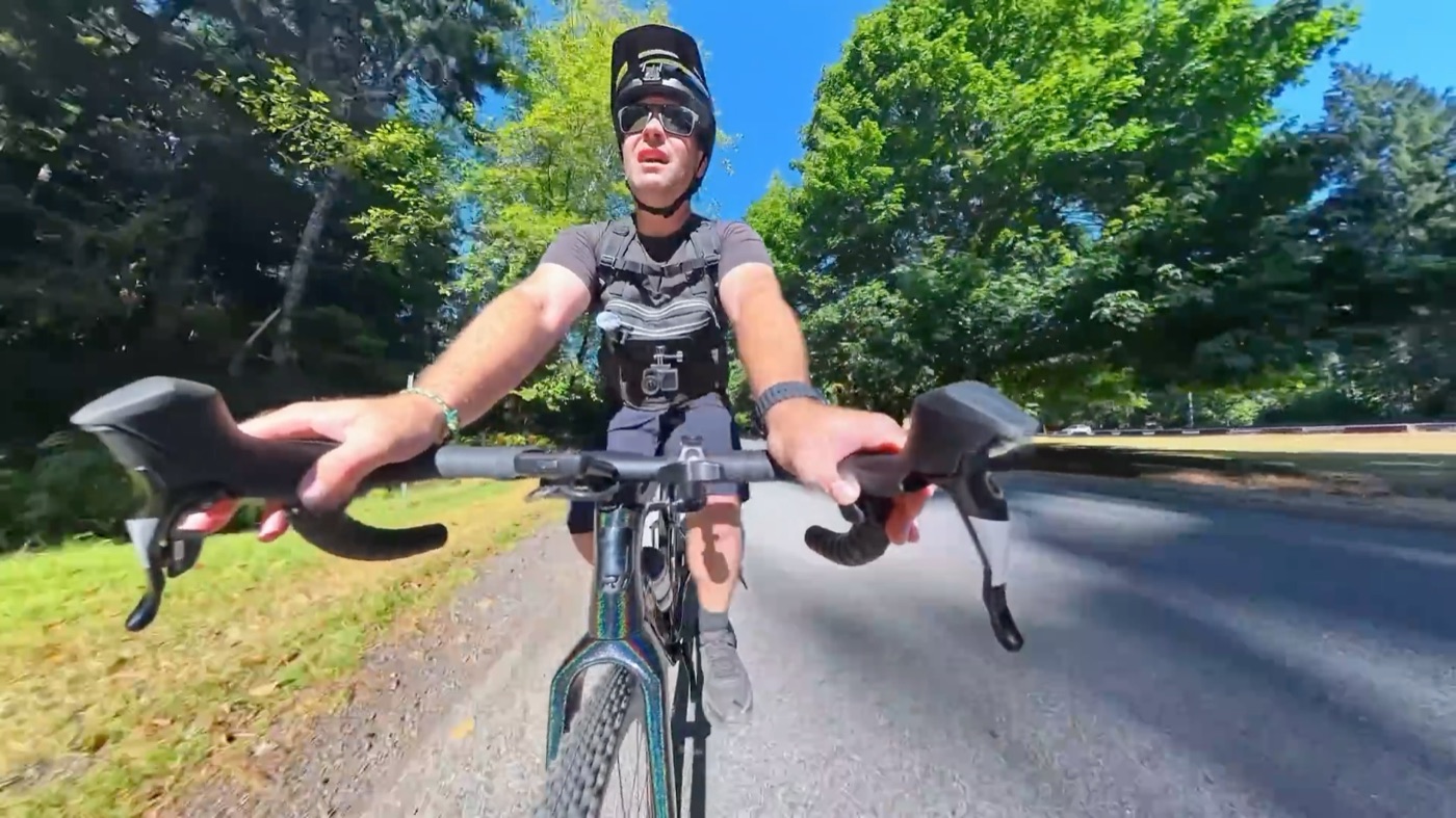 Riding the CF Racer1 on a tree-lined road