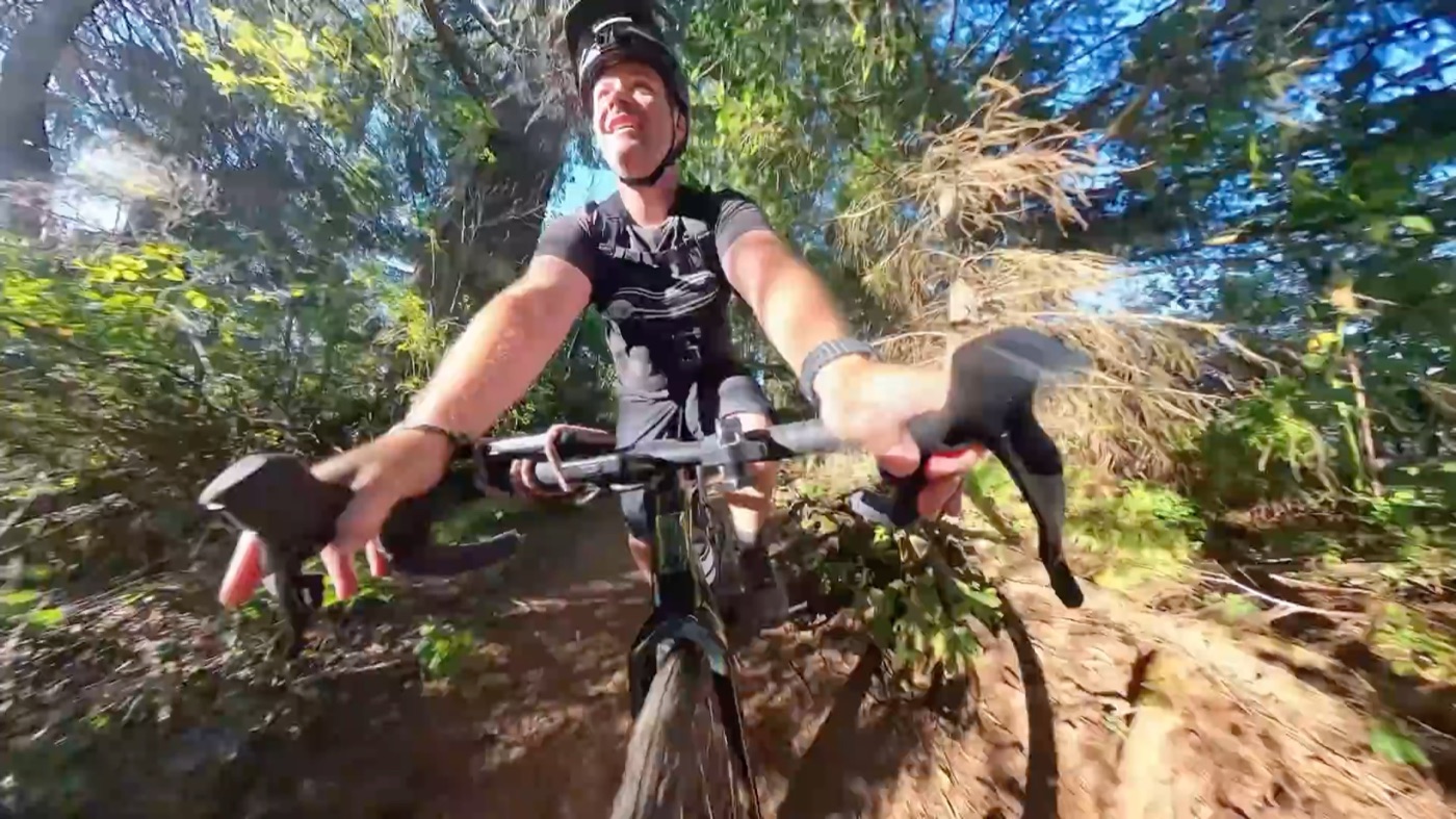 Riding the CF Racer1 through a wooded trail