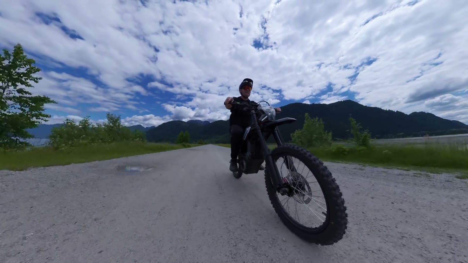 Ben standing with the Segway Xaber 300 on a gravel road by the water