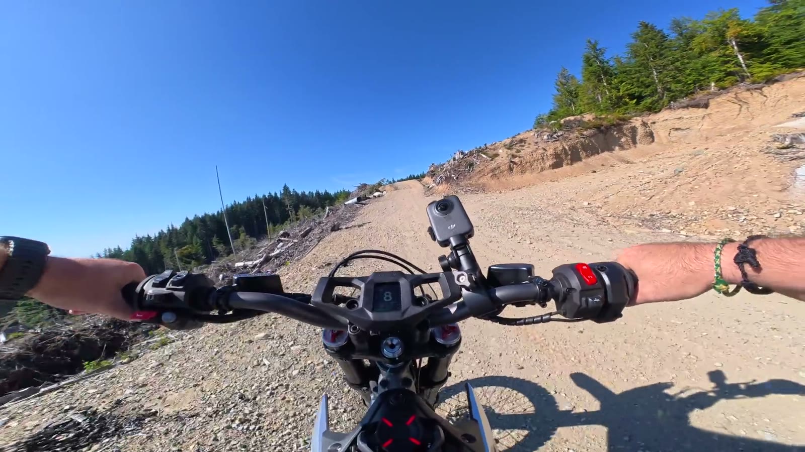 Handlebar view of the Segway Xaber 300 on a mountain gravel road