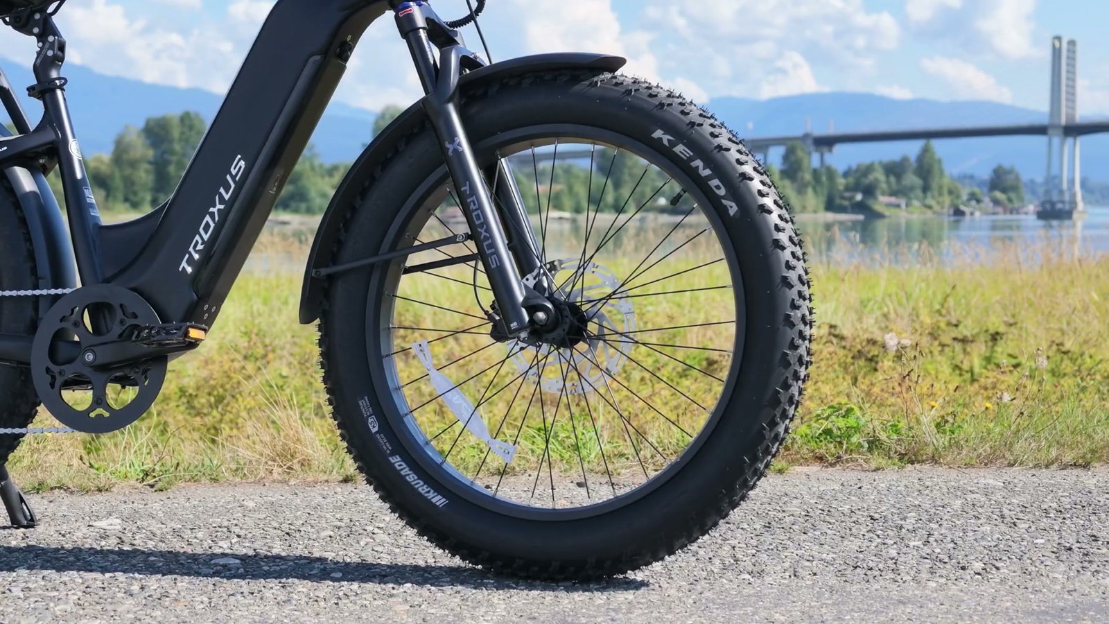 Troxus Explorer Plus iQ parked on a gravel path by the river