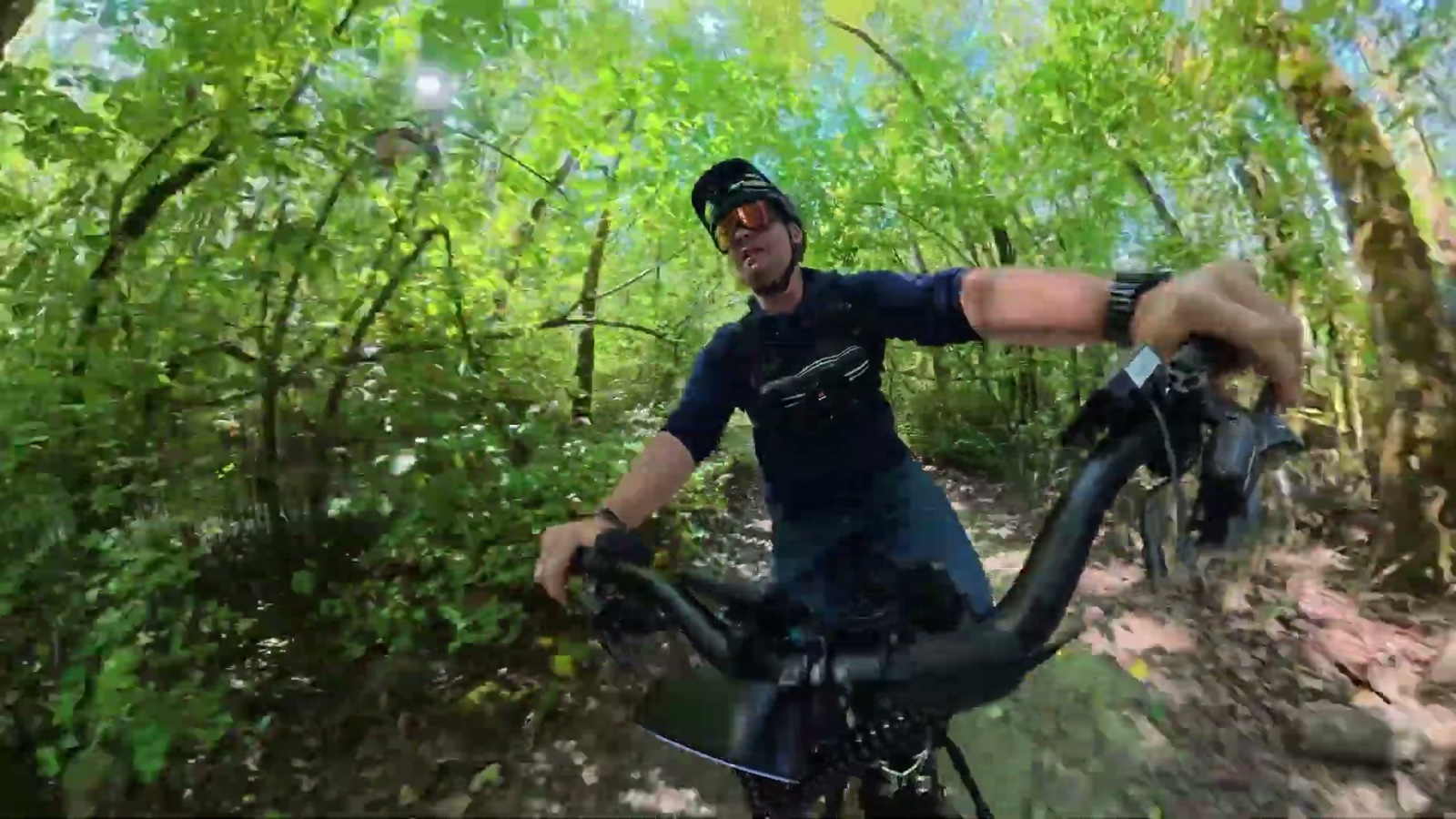 Ben riding the Explorer Plus iQ through a forest trail