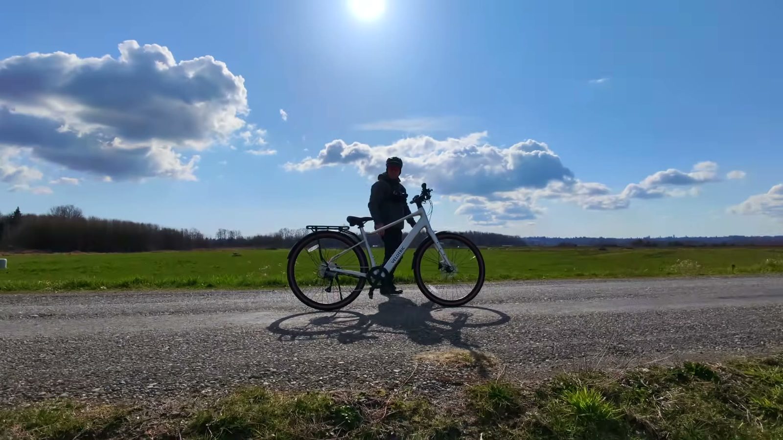 Ben standing with the Lightning Silver Velotric Tempo on a gravel road under a big open sky