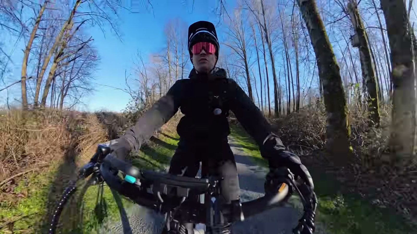 Ben riding the Breeze 1 along a tree-lined gravel path