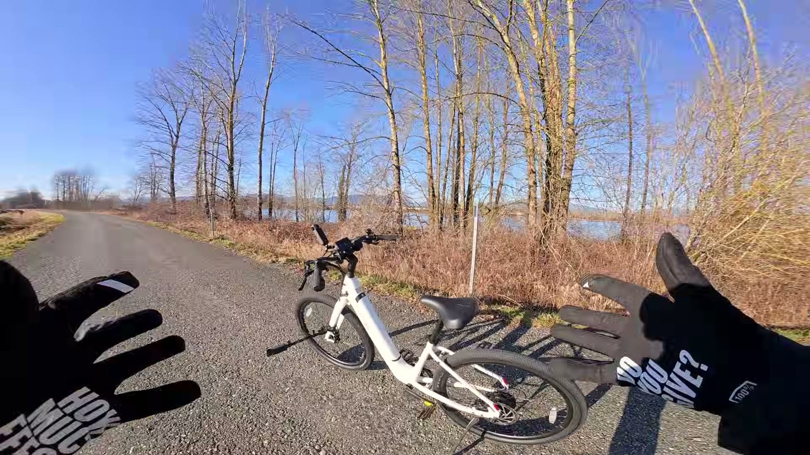 Ben gesturing at the parked Breeze 1 from above on a riverside path