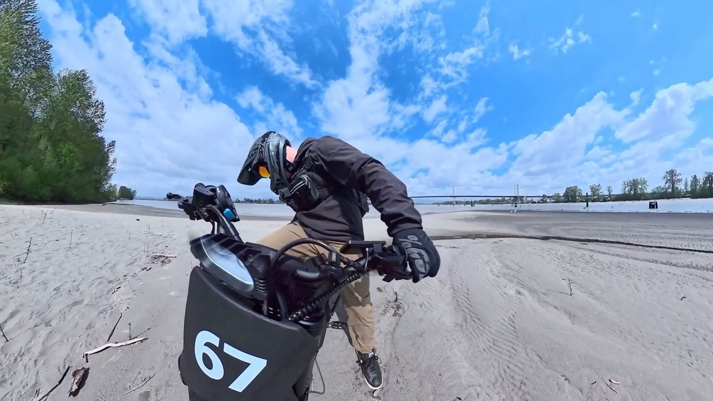 Riding the Yozma IN 10 Pro across loose beach sand