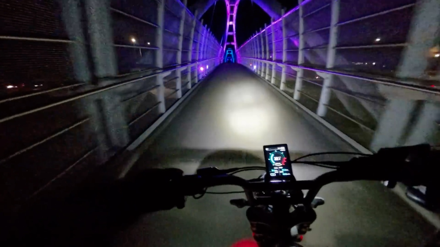 Riding the Motor Goat through a lit bridge tunnel at night
