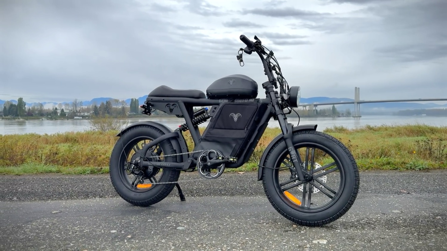 Motor Goat in Black and Gunmetal Grey Stealth, side profile by the river