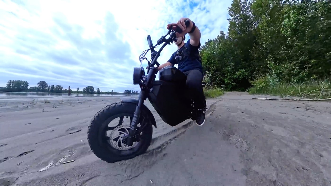 Riding the Mini Goat on beach sand